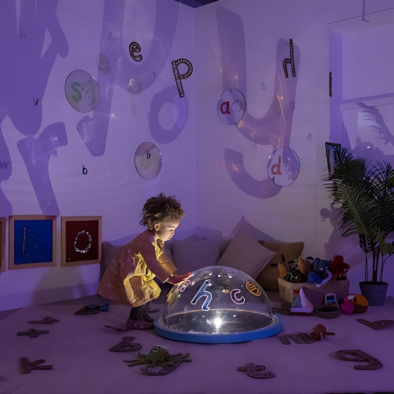 TTS Immersive Projector in use indoors with child engaged in active sensory and light exploration play