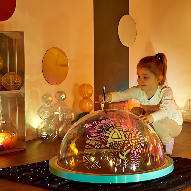 TTS Immersive Projector rechargeable light dome with child sitting during sensory exploration, casting shadows onto walls