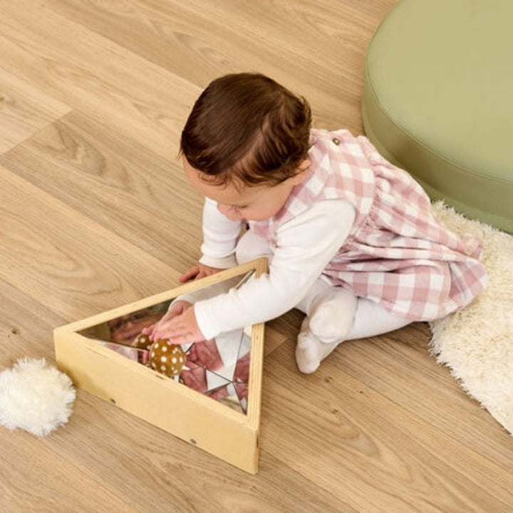 Child actively playing with the TTS Kaleidoscope Mirror, demonstrating visual tracking and gross motor engagement through sensory mirror play