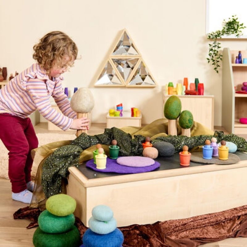 Child engaging in mirror play with the TTS Kaleidoscope Mirror set, demonstrating visual tracking and sensory exploration in a nursery setting