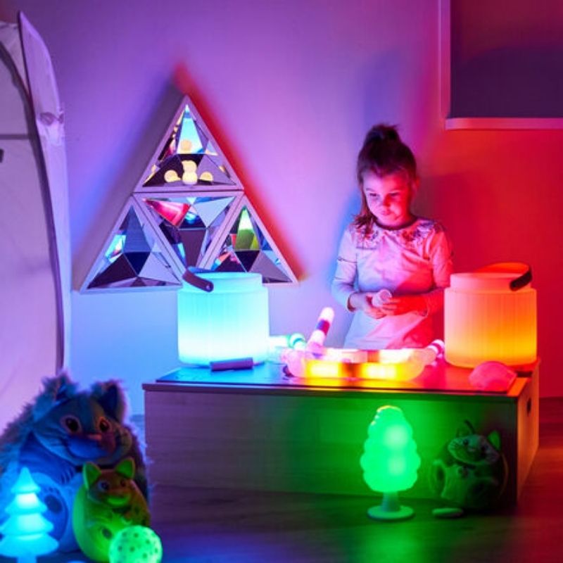 Girl playing in front of the TTS Kaleidoscope Mirror set, illustrating self-awareness and visual development during mirror play