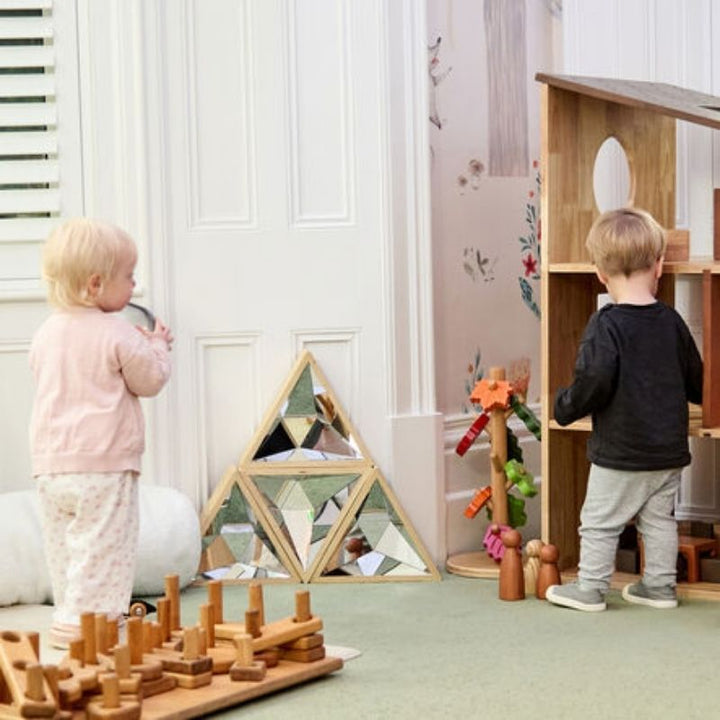 Multiple children engaging with the TTS Kaleidoscope Mirror in an active play room, showing social interaction and group sensory exploration