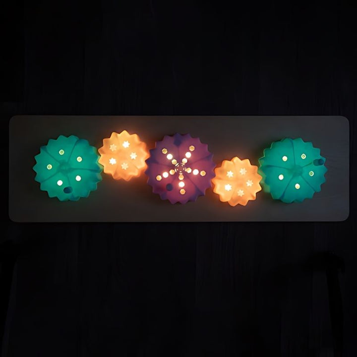 TTS Light Up Cog Board mounted to a wall, demonstrating the versatile installation option for classrooms and therapy spaces