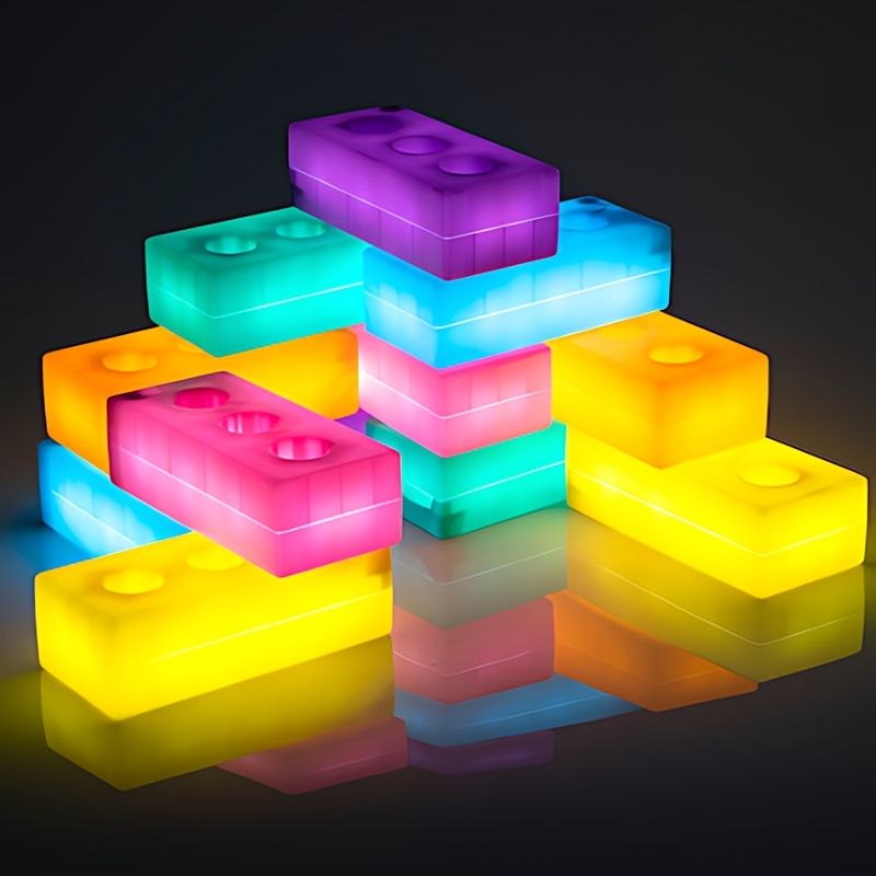 TTS Light Up Glow Construction Bricks illuminated in a landscape arrangement, showing the vivid LED glow of six colours for sensory and STEAM play