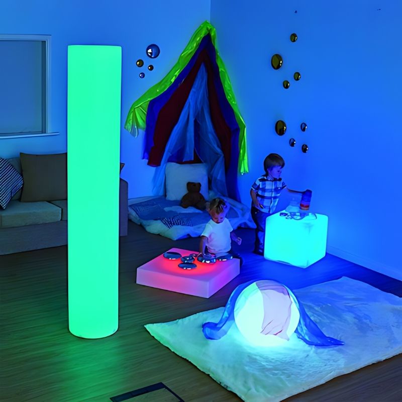 Two children engaged in active sensory play around the TTS Colour Changing Light Up Cube, showing the LED furniture cube in a group learning environment