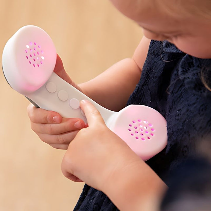 Child actively playing with TTS Light Up Phone, exploring cause and effect and language development through sensory role play