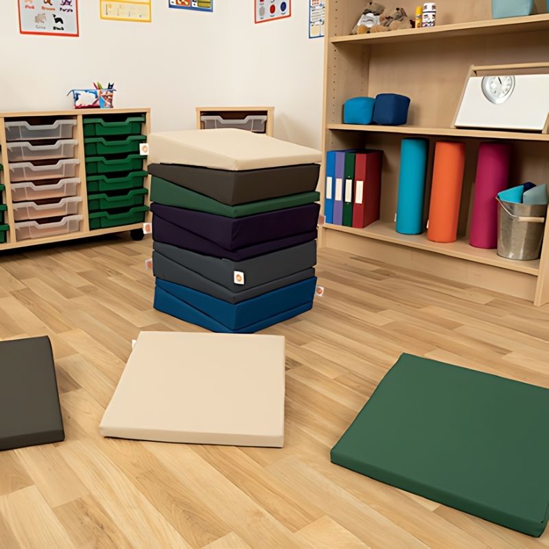 TTS Maxi Wedge foam wedge cushions in dark colours arranged indoors, supporting flexible classroom and sensory space seating