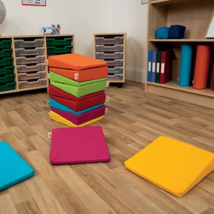 TTS Maxi Wedge 12 Pack in multicolour arrangement, used as ergonomic sensory seating for active sitting in classrooms and therapy rooms