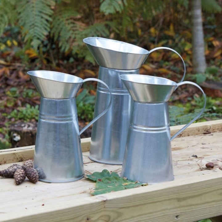 TTS Metal Messy Play Set in use in an outdoor early years setting, supporting tactile development, imaginative role play, and fine motor skills for all children
