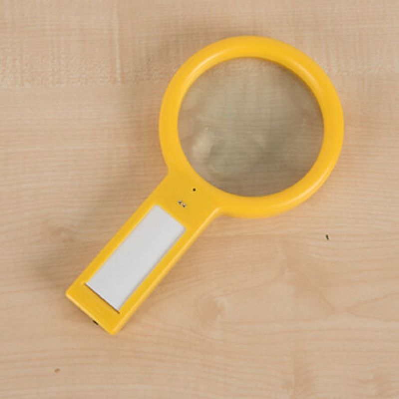 Close-up of the TTS Recordable Magnifying Glass showing the voice record and playback button, designed for easy use by young children during science activities