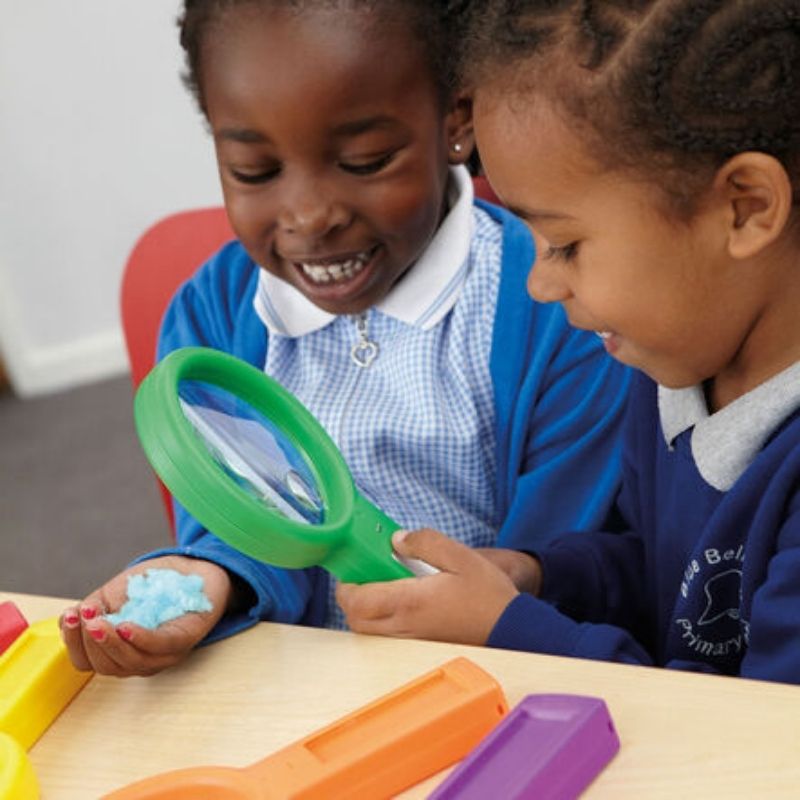 Group of children using TTS Recordable Magnifying Glasses during a classroom science activity, demonstrating how the 6-pack supports simultaneous group learning and observation