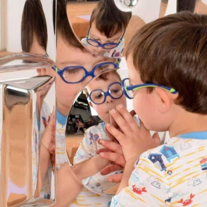 Close-up of a boy interacting with the TTS Sensory Bubble Shapes Mirror, showing the three distinct shatterproof convex bubble shapes that encourage sensory exploration and spatial awareness