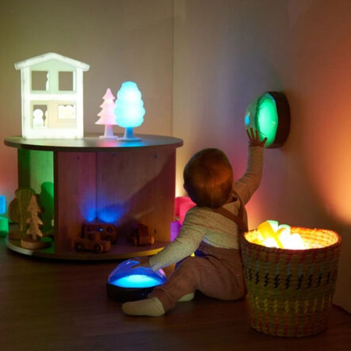 Child's hands interacting with the TTS Light Up Recordable Dome glowing blue, showing the tactile and visual sensory feedback during hands-on developmental play