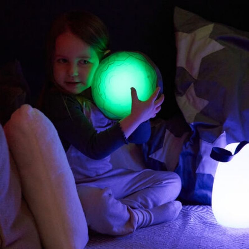 Child pressing a TTS Light Up Recordable Dome glowing green, demonstrating the cause-and-effect LED light response for sensory and motor development
