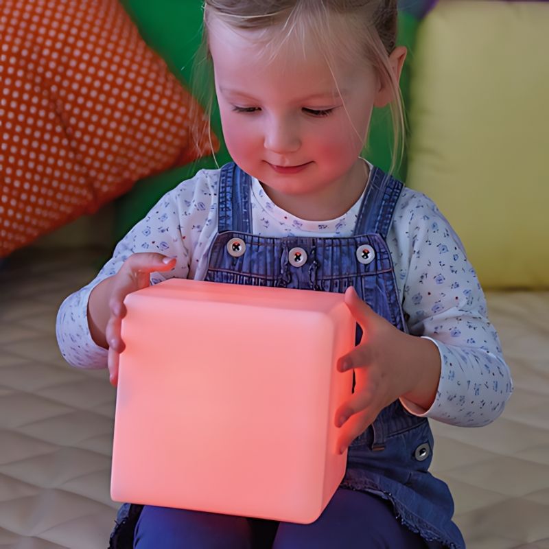 TTS Sensory Glow Construction Blocks close-up view showing a child's hands holding a colour-changing glow cube during sensory play