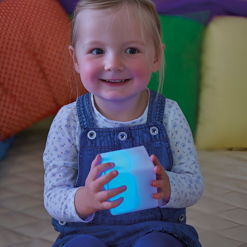TTS Sensory Glow Construction Blocks detail view of a child engaging with the light up cubes, showing colour-changing glow for early years and sensory room use