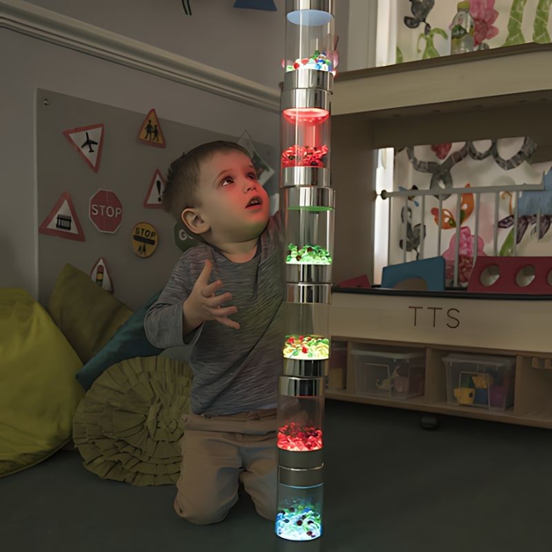 Child actively playing with TTS Sensory ICT Glow Set components, showing hands-on sensory exploration and cause-and-effect learning