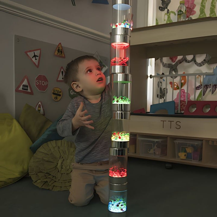 Child actively playing with TTS Sensory ICT Glow Set components, showing hands-on sensory exploration and cause-and-effect learning
