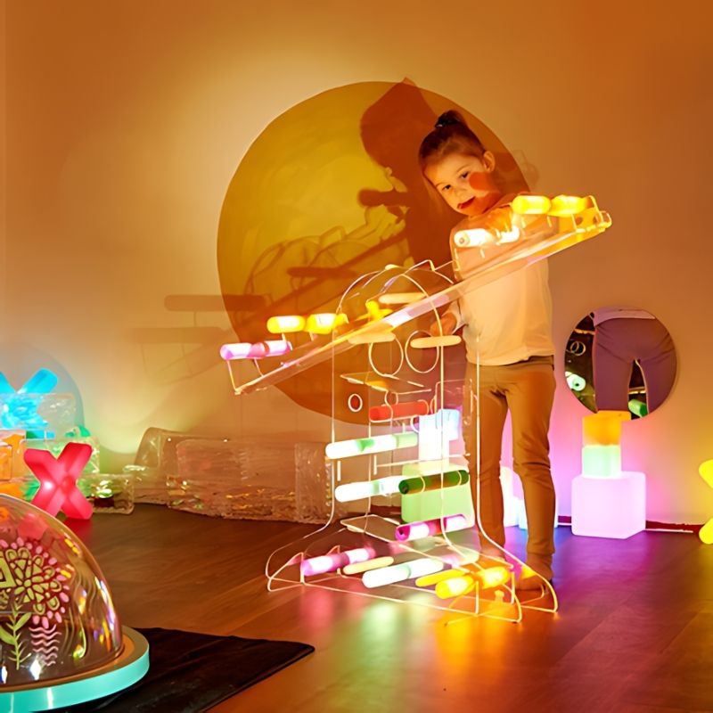 TTS STEAM Discovery Centre with a child standing and engaging in hands-on STEAM exploration at the acrylic balance and ramp station