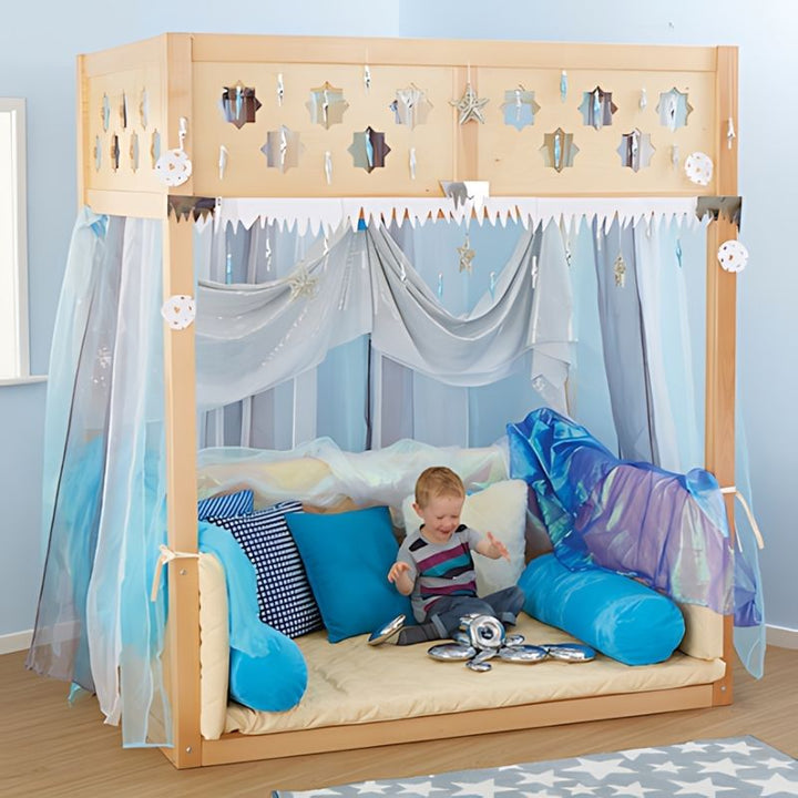 TTS Super Seat Indoor Wooden Den Structure with a child engaged in solo sensory play inside the cosy beech wood enclosure