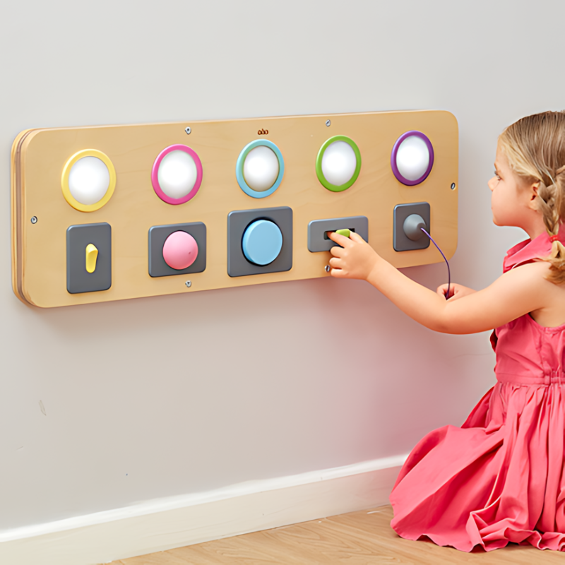 TTS Switch and Press Fine Motor Board shown in use by a young girl, an interactive wooden sensory activity for early years fine motor development