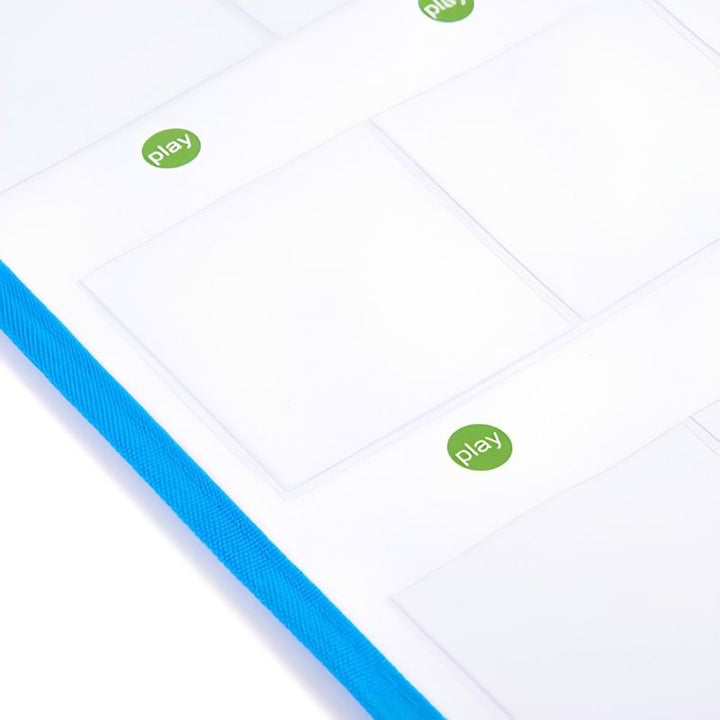Angled close-up of the TTS Interactive Talking Mat surface showing clear card pockets, green play buttons and the durable blue fabric binding edge