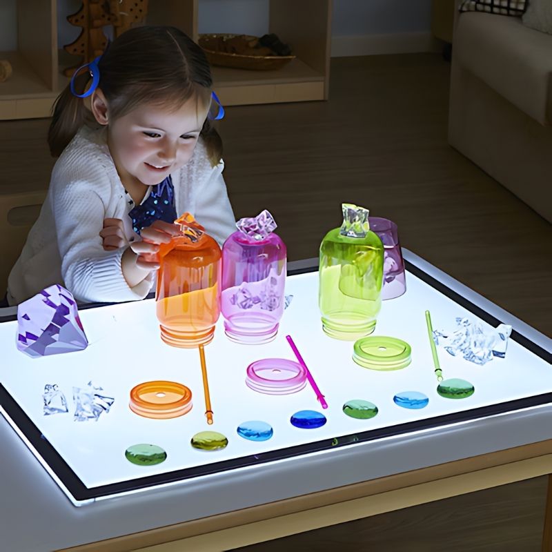 TTS Ultra-Bright LED Light Panel in use during active sensory play, showing a girl exploring the illuminated surface - a Canadian-made LED light panel for classrooms and therapy rooms