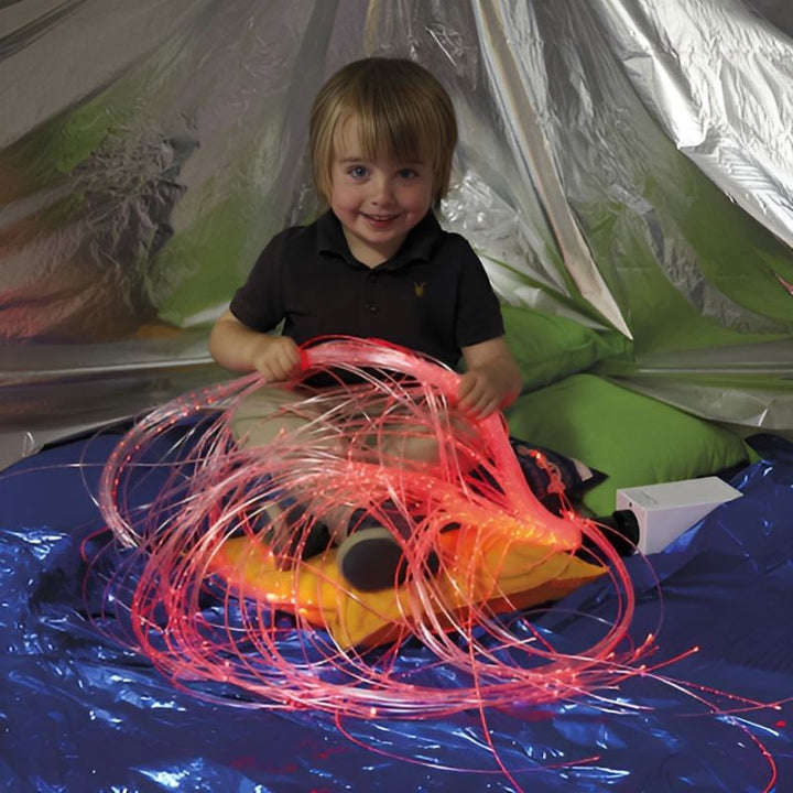 TTS Rechargeable Wireless Sensory Fibre Optic Strands held by a child during active sensory play, showing the colour-changing LED light effect