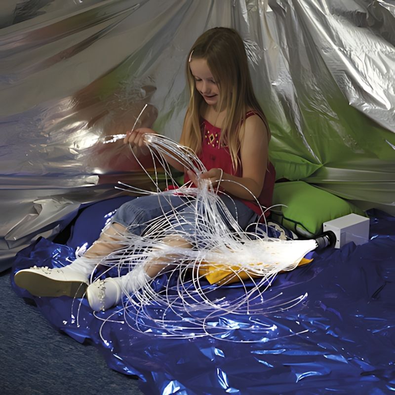 TTS Wireless Rechargeable Fibre Optic Strands in use by a girl during sensory light exploration, demonstrating the wire-free design and glowing strands