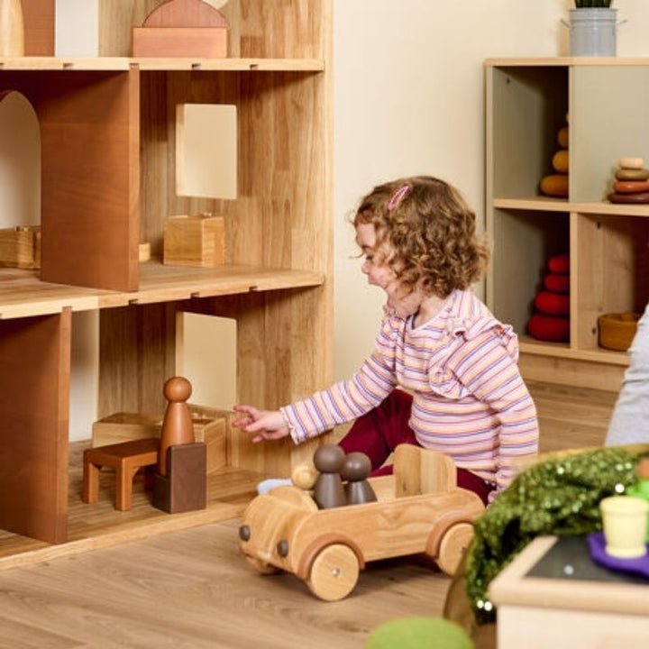 TTS Giant Wooden Car in use within a small world play scene, demonstrating gross motor engagement and open-ended imaginative play for children in early years and preschool settings