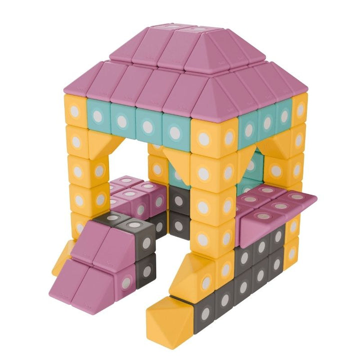 TUKI BIG Magnetic Blocks Builder 94 arranged into a house figure, showing the architectural floor-scale construction complexity that 94 large-format 10cm foam blocks in 8 Signature shapes enables for group building sessions with 5-8 children