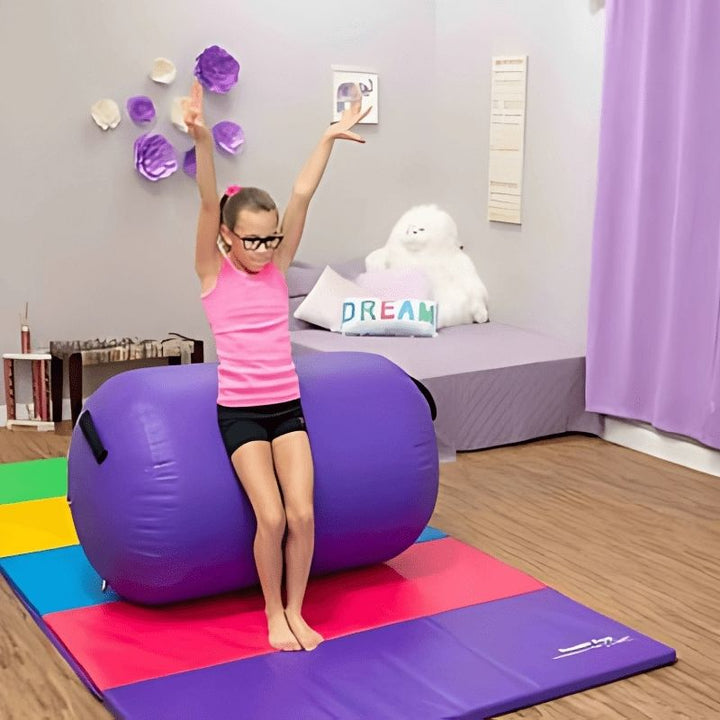Girl actively using the Tumbl Trak Air Barrel in Purple for gymnastics skill training, demonstrating the bouncy inflatable surface that assists back handspring, walkover, and body awareness progressions