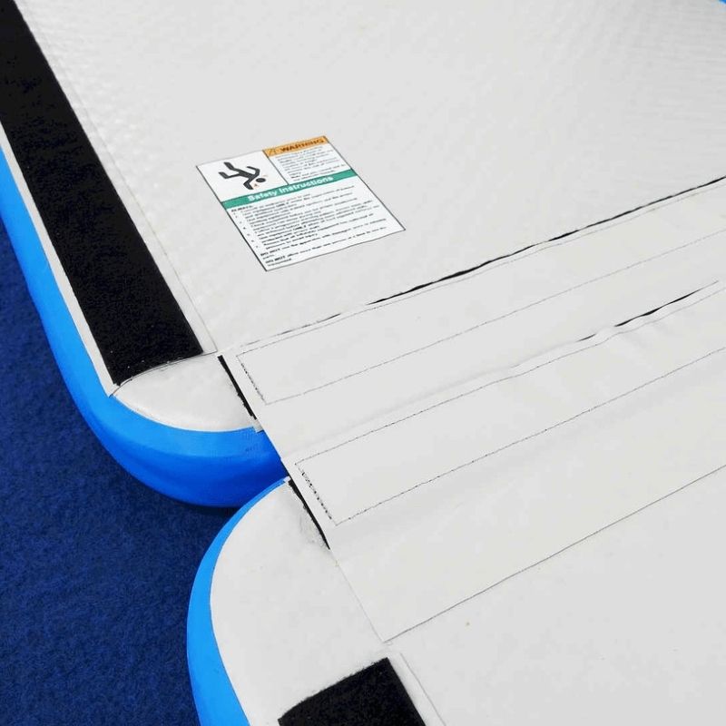 Close-up of the Tumbl Trak Air Floor Velcro end flap showing the end-to-end connectivity system that allows multiple Air Floor units to be joined for extended tumbling passes and obstacle course layouts
