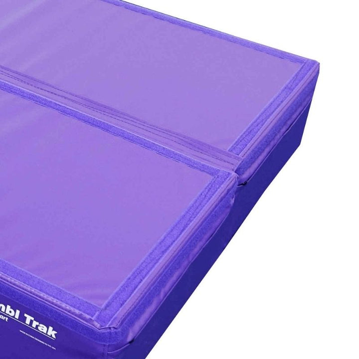 Edge-on view of the Tumbl Trak Booster Block showing the 8-inch height profile and 18 oz. knife-coated vinyl covering over the firm polyurethane foam core rated to 200 lbs for gymnastics and plyometric training