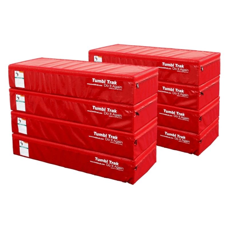Eight Tumbl Trak Booster Blocks in Red arranged in a multi-block configuration, showing the side-by-side and end-to-end Velcro connection options for building custom gymnastics training and obstacle course layouts