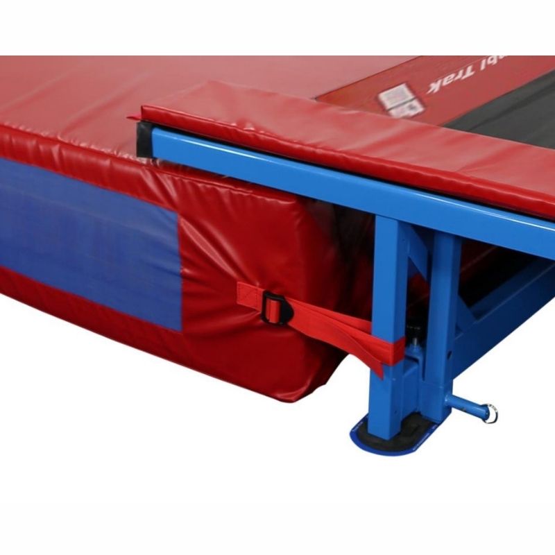 Close-up detail of the Tumbl Trak Dismount Mat showing the 18 oz. coated vinyl construction, nylon mesh breather fabric side panels for air escape, and the heavy-duty webbing strap attachment system for securing the mat to the Tumbl Trak frame end