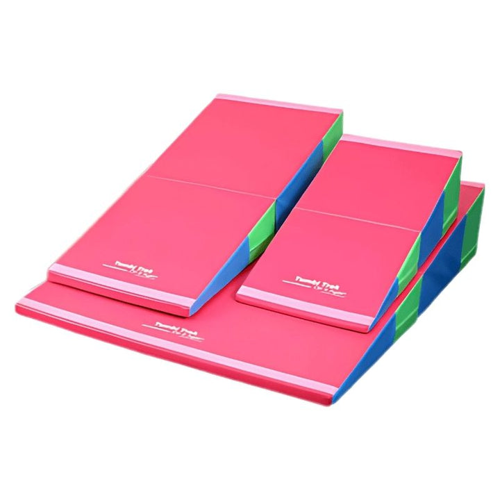 Tumbl Trak Folding Incline Mat in Bright Pastel Rainbow colourway, a cheese mat suitable for home gymnastics training, OT therapy rooms, and sensory obstacle courses