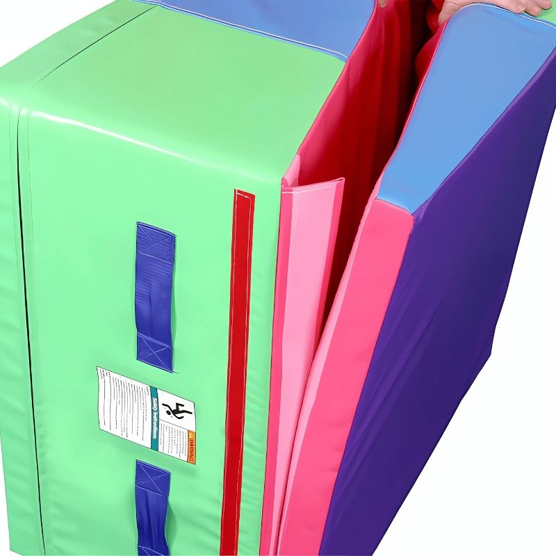 Tumbl Trak Folding Incline Mat folded into a stable block position with Velcro flap secured, showing dual-use function as a spotting block, jumping platform, and obstacle course element