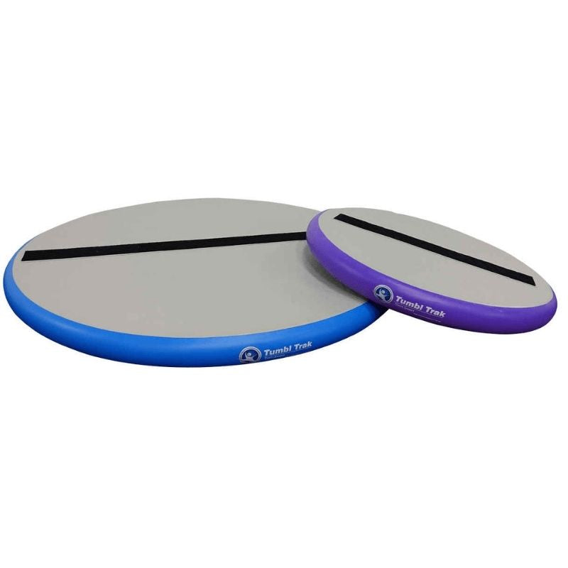 Tumbl Trak Hot Spot showing both the blue and purple colour variants of the circular inflatable gymnastics jump and take-off trainer, available in 3ft and 5ft diameter with 4-inch loop Velcro line for punch fronts, back tucks, and jump training