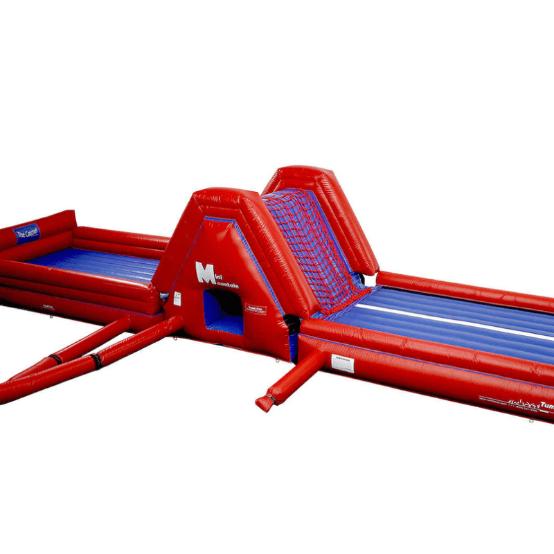 Tumbl Trak Mini Mountain set up in a gymnasium showing the inflatable play station attached to the end of an Air Trak using the Velcro end flap and D-ring strap connection, creating a complete bouncing, climbing, and tunneling activity station