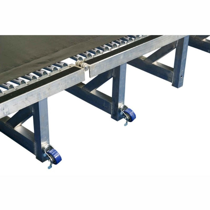 Close-up view of the Tumbl Trak Porta Trak showing the aluminium frame detail, polypropylene bed surface, 4-inch springs, and folding hinge construction that makes this portable gymnastics tumbling track half the weight of the Original Tumbl Trak