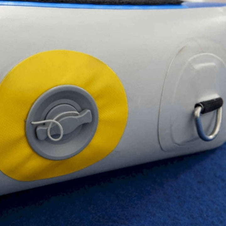 Close-up detail of the Tumbl Trak Power Launch 4x6ft inflatable training mat showing the loop Velcro perimeter, D-ring corner attachment, and double-wall construction used for gymnastics training, OT therapy, and sensory movement play