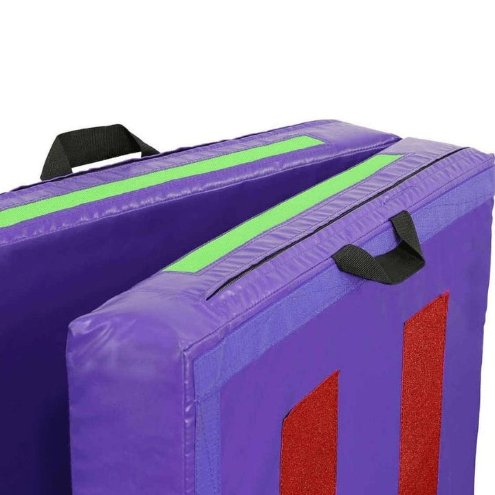 Corner view of the Tumbl Trak Practice Mat in Purple and Lime Green showing the Velcro fastener system on the 6-inch or 8-inch thick mat that keeps the mat locked closed in block configuration and enables end-to-end connection