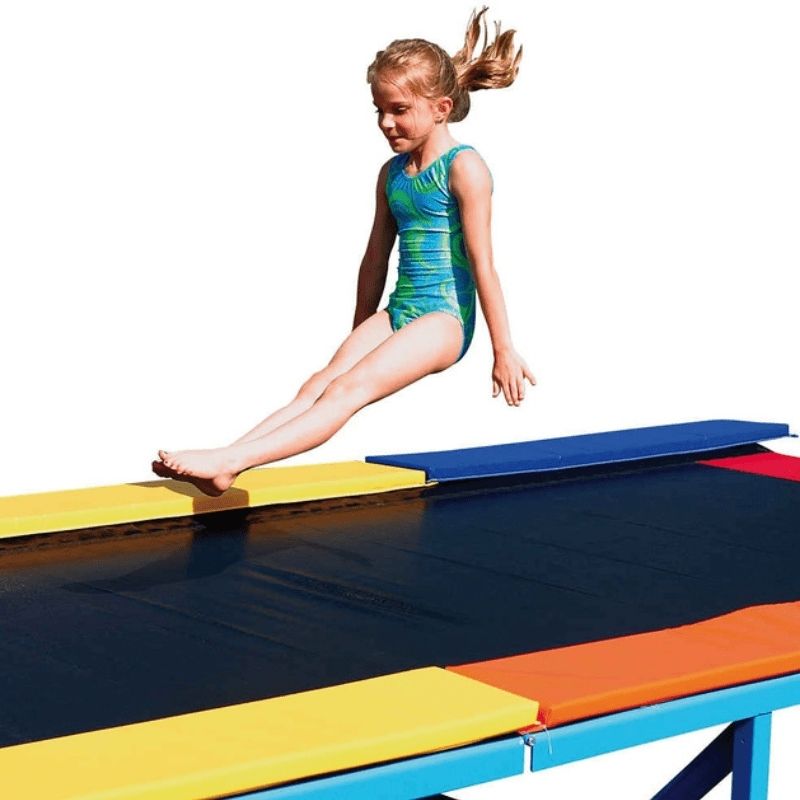 Close-up of a girl mid-jump on the Tumbl Trak Recreational Tumbling Track, demonstrating the safe, low-impact spring surface used for gross motor development and beginner tumbling skill building