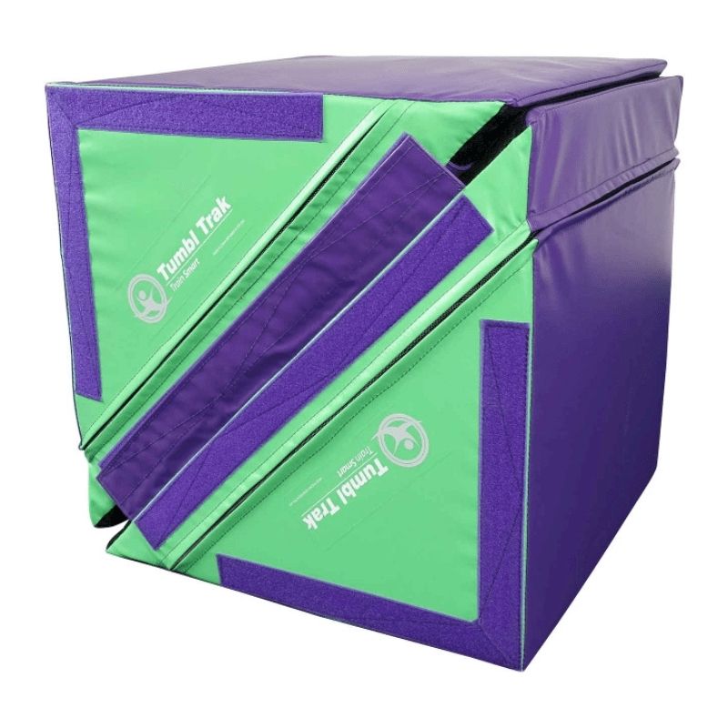 Tumbl Trak Slanted Ninja Steps Purple and Green variant showing the angled triangle profile and Velcro flap system used to transform the pair into cubes, hurdles, and speed bumps