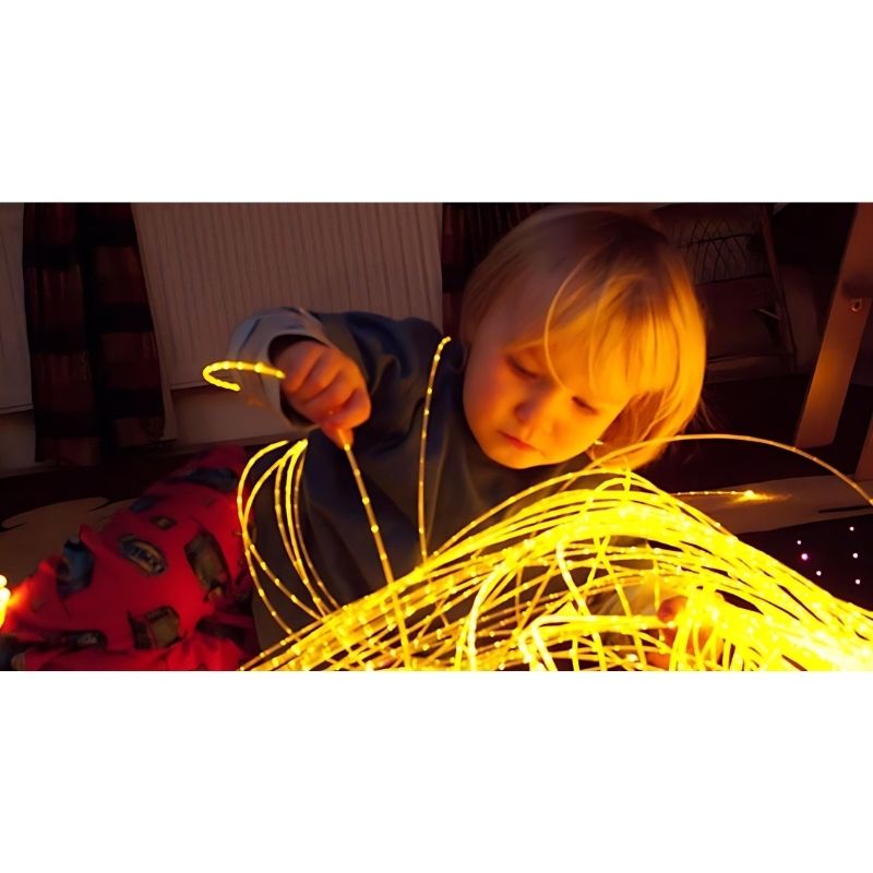UFO fibre optic spray harness polymer tails in use, providing safe tactile and visual stimulation for sensory room environments