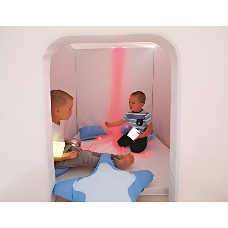 Child actively playing inside the Wesco Sensory Cabin, showing the spacious interior of this noise-reducing foam sensory room cabin for children in therapy and classroom settings