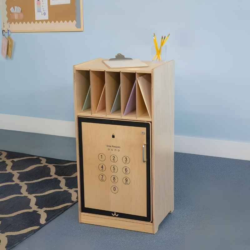 Whitney Brothers Cell Phone Locker WB1217 in a K-8 classroom setting, showing the locking door with cell phone graphic, open folder compartment above, and natural birch finish