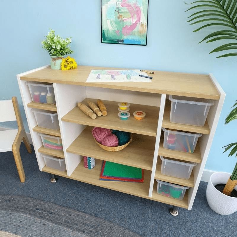 Whitney Brothers elevatED Combo Tray Storage Cabinet in a classroom setting, showing the three open centre shelves and two side tray cubby compartments in the contemporary two-tone design