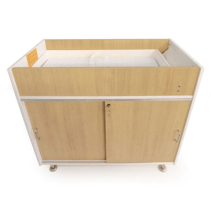 Second clean view of the Whitney Brothers elevatED Infant Changing Cabinet showing the two fixed interior shelves behind the lockable sliding doors and the 7.5" deep changing well
